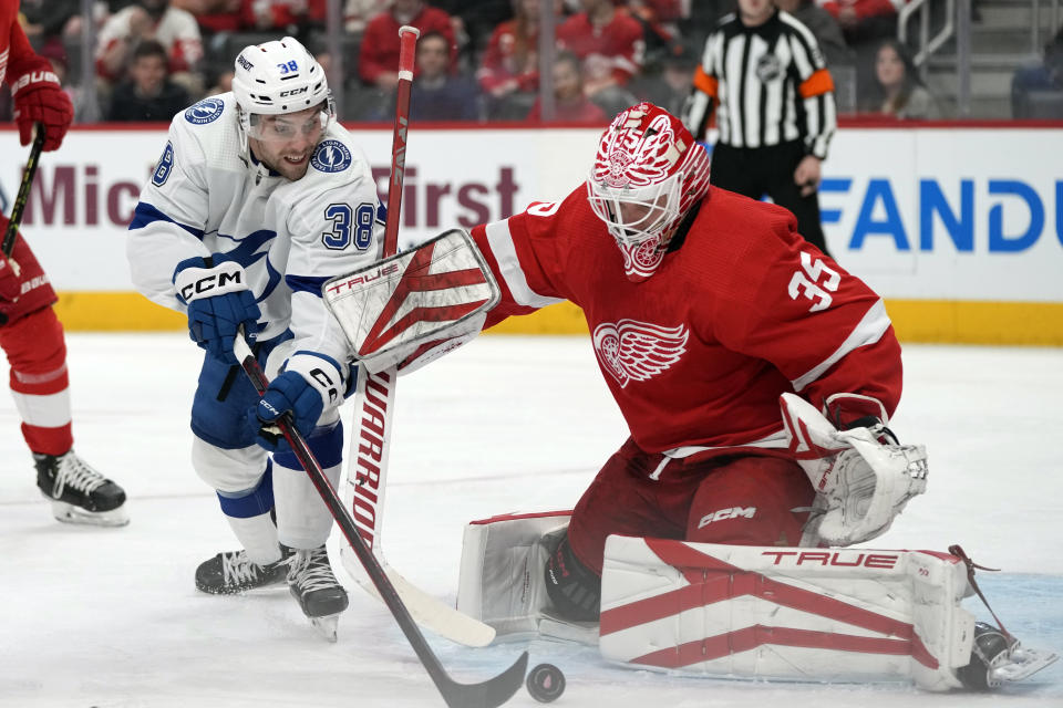 Detroit Red Wings goaltender Ville Husso (35) stops a shot by Tampa Bay Lightning left wing Brandon Hagel (38) during the second period of an NHL hockey game, Wednesday, Dec. 21, 2022, in Detroit. (AP Photo/Carlos Osorio)