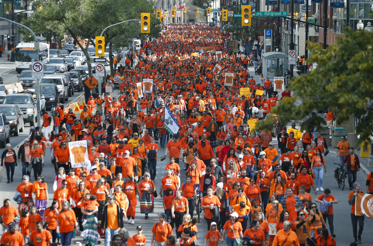 People attend the second annual Orange Shirt Day Survivors Walk and PowWow on National Day for Truth and Reconciliation in Winnipeg, Friday, September 30, 2022. The Manitoba government will not make Orange Shirt Day a statutory holiday this year. Premier Heather Stefanson says consultations are ongoing and there is still not a consensus on how the day should be marked. THE CANADIAN PRESS/John Woods