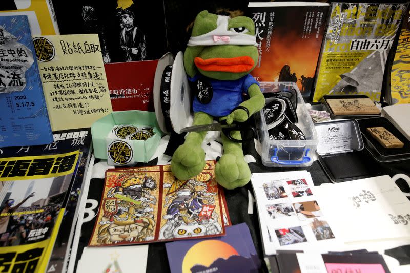 Postcards and various posters supporting Hong Kong anti-government protester are seen in Aegis, a restaurant that offer work opportunities to Hong Kongers seeking asylum in Taipei,