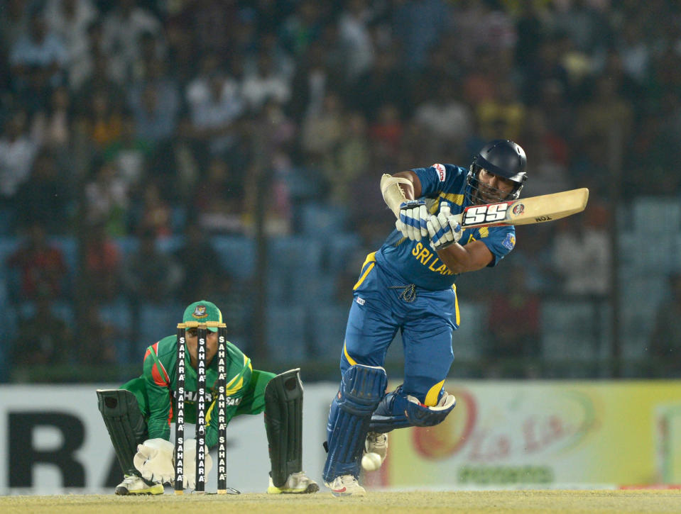 Sri Lankan batsman Kumar Sangakkara (R) plays a shot as Bangladeshi wicketkeeper Anamul Haque looks on during the second T20 cricket match between Bangladesh and Sri Lanka at The Zahur Ahmed Chowdhury Stadium in Chittagong on February 14, 2014. AFP PHOTO/ Munir uz ZAMAN