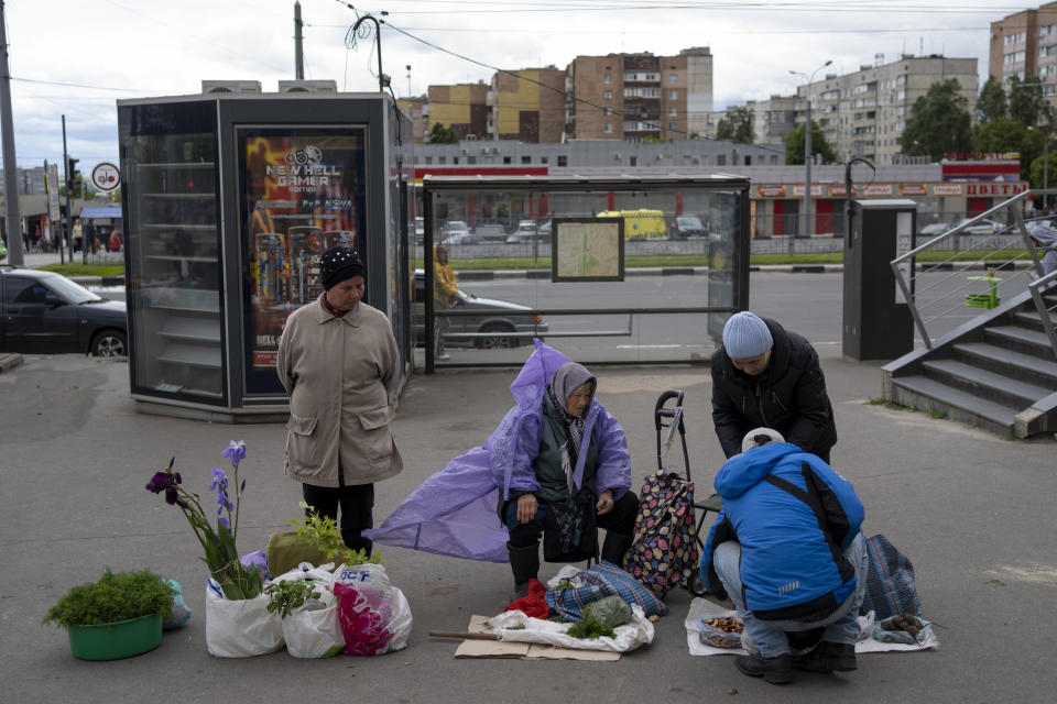 Vendors sell plants and vegetables in a street market in Kharkiv, Ukraine, Sunday, May 22, 2022. (AP Photo/Bernat Armangue)