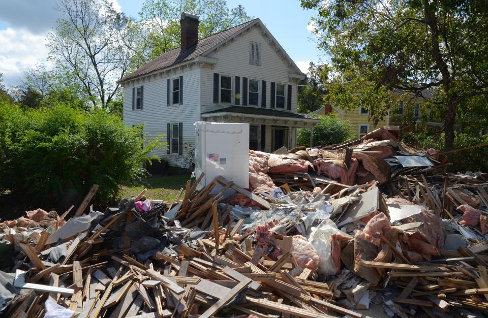 A pile of Hurricane Florence storm debris covers a sidewalk on Main Street in Pollocksville in September 2018.