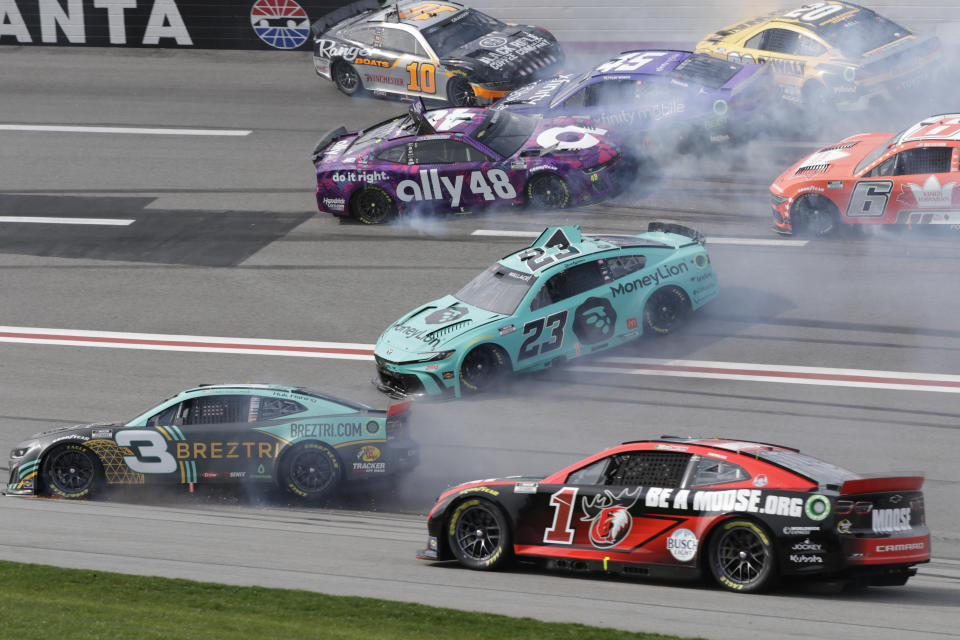 NASCAR drivers Austin Dillon (3), Bubba Wallace (23), Alex Bowman (48), Tyler Reddick (45), Noah Gragson (10), Brad Keselowski (6) and Christopher Bell (20) crash during the NASCAR auto race at Atlanta Motor Speedway Sunday, Feb. 25, 2024, in Hampton , Ga. (AP Photo/Russell Norris)