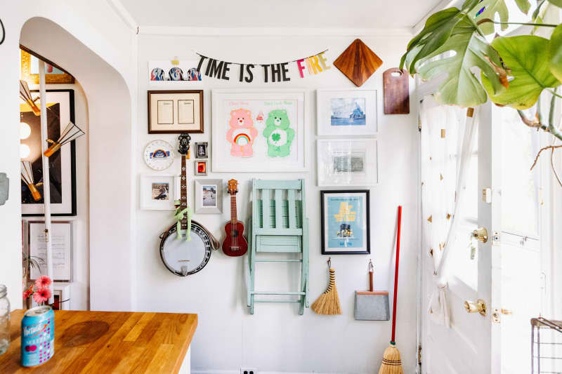 A gallery wall of items in a white-walled kitchen