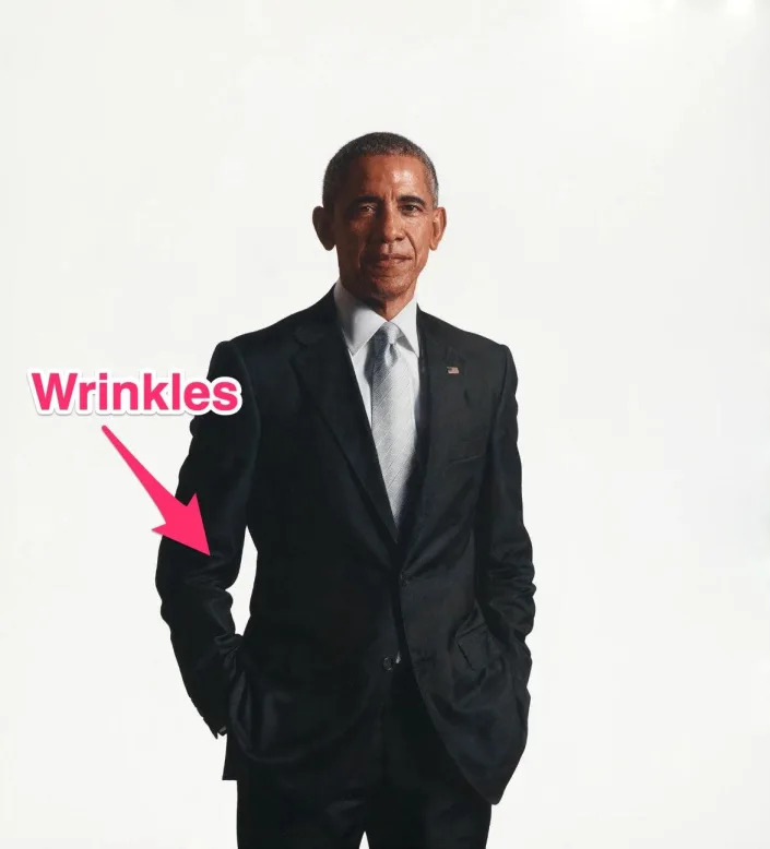 Barack Obama's White House portrait with an arrow pointing to wrinkles in his suit