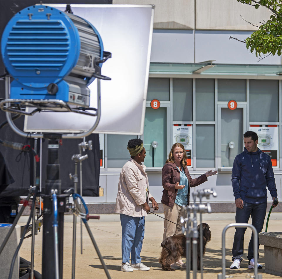 Cleveland Browns quarterback Baker Mayfield, right, performs with actors during a Progressive Insurance commercial shoot at FirstEnergy Stadium, Thursday, July 22, 2021, in Cleveland. (AP Photo/David Dermer)