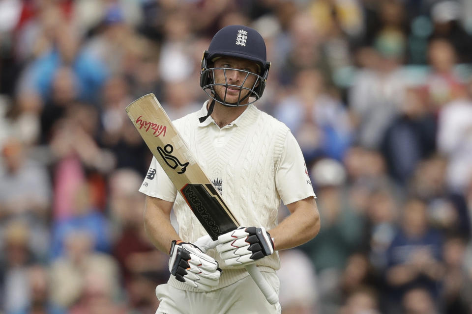 England's Jos Buttler celebrates after reaching 50 runs during the fifth cricket test match of a five match series between England and India at the Oval cricket ground in London, Saturday, Sept. 8, 2018. (AP Photo/Matt Dunham)