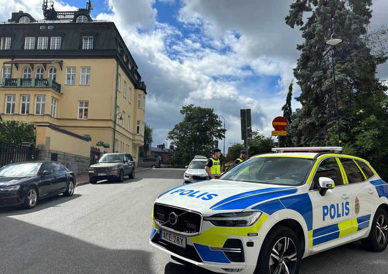 Police stand guard near the Iraqi embassy ahead of a demonstration in Stockholm