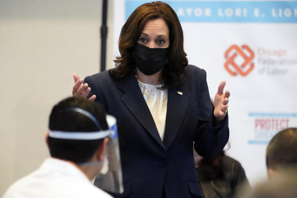 Vice President Kamala Harris looks at Osman Meah, a pharmacy manager at Jewel Osco who was giving the vaccinations, as she visits a COVID-19 vaccination site Tuesday, April 6, 2021, in Chicago. The site is a partnership between the City of Chicago and the Chicago Federation of Labor. (AP Photo/Jacquelyn Martin)