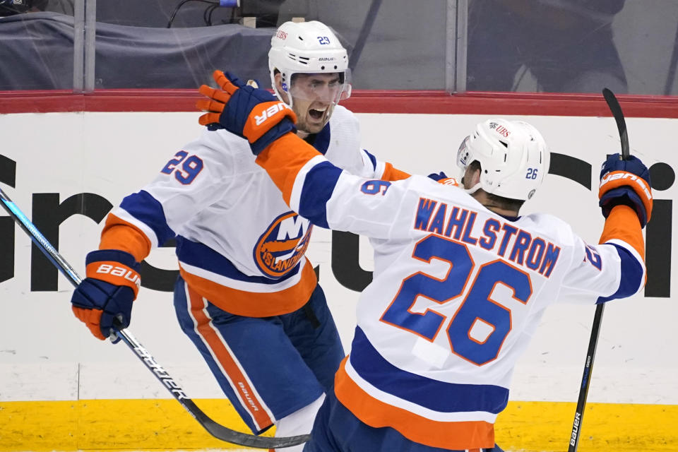 New York Islanders' Brock Nelson (29) celebrates after scoring during the third period in Game 1 of an NHL hockey Stanley Cup first-round playoff series against the Pittsburgh Penguins in Pittsburgh, Sunday, May 16, 2021. The Islander won in overtime 4-3. (AP Photo/Gene J. Puskar)