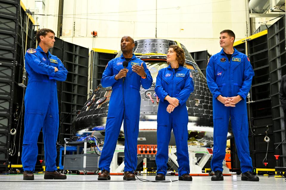 The crew of Artemis II, astronauts Reid Wiseman, commander; Victor Glover, pilot; Christina Hammock Koch, mission specialist; and Canadian astronaut Jeremy Hansen, mission specialist, gather in front of the Artemis II crew module in August at the Kennedy Space Center in Cape Canaveral, Florida.