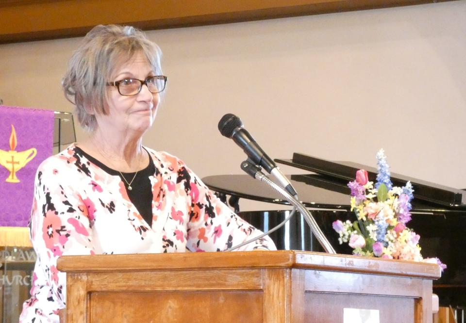 Joanne Weisenauer, chaplain of the newly chartered Salvation Army Women's Auxiliary of Bucyrus, delivers the opening prayer during the group's charter meeting Monday.