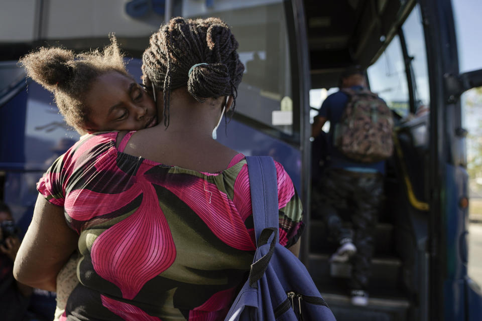 FILE - In this Sept. 22, 2021, file photo a child sleeps on the shoulder of a woman as they prepare to board a bus to San Antonio moments after a group of migrants, many from Haiti, were released from custody upon crossing the Texas-Mexico border in search of asylum in Del Rio, Texas. In the past week, the push to change the nation's immigration laws and create a path to citizenship for young immigrants brought illegally to the country as children faced a serious setback on Capitol Hill. Bipartisan negotiations to overhaul policing collapsed and searing images of Haitian refugees being mistreated at the U.S.-Mexico border undermined President Joe Biden's pledge of humane treatment for those seeking to enter the United States. (AP Photo/Julio Cortez, File)