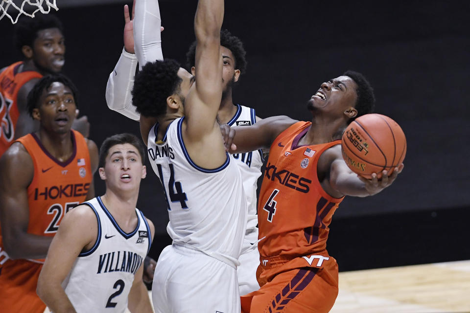 Virginia Tech's Nahiem Alleyne (4) shoots as Villanova's Caleb Daniels (14) defends during the second half of an NCAA college basketball game, Saturday, Nov. 28, 2020, in Uncasville, Conn. (AP Photo/Jessica Hill)