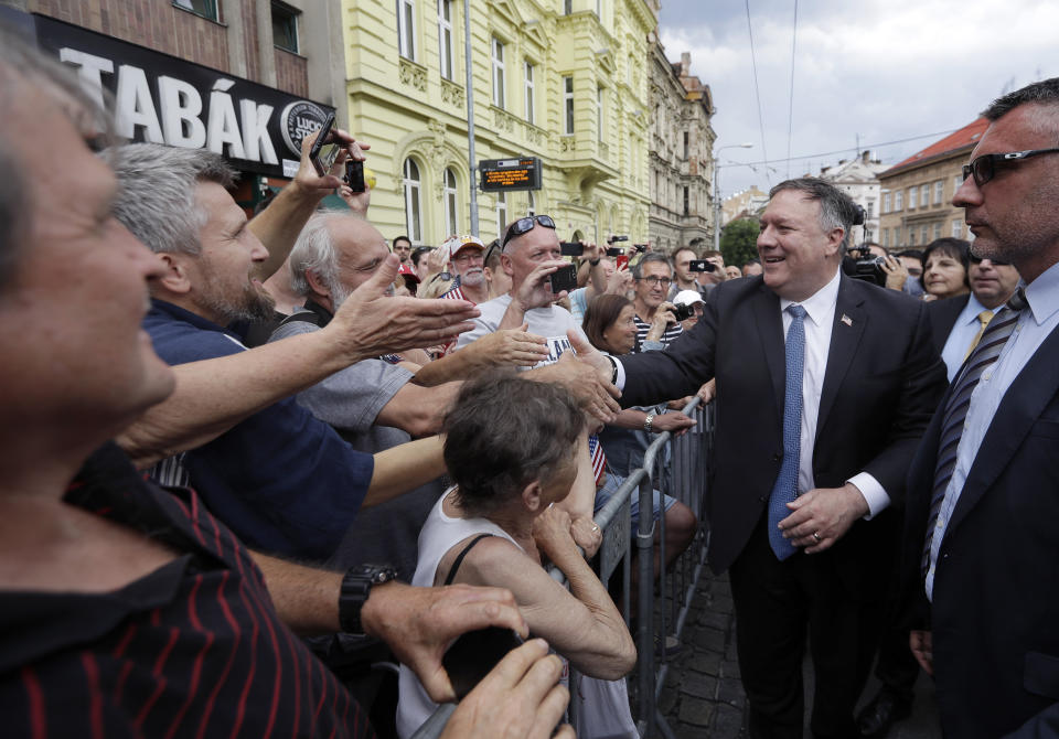 U.S. Secretary of State Mike Pompeo, right, shakes hands with citizens in Pilsen near Prague, Czech Republic, Tuesday, Aug. 11, 2020. U.S. Secretary of State Mike Pompeo is in Czech Republic at the start of a four-nation tour of Europe. Slovenia, Austria and Poland are the other stations of the trip. (AP Photo/Petr David Josek, Pool)