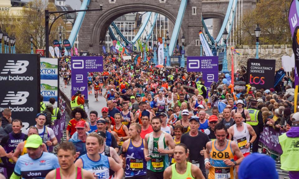 <span>Thousands of runners cross Tower Bridge during the 2023 London Marathon.</span><span>Photograph: Vuk Valcic/Alamy</span>