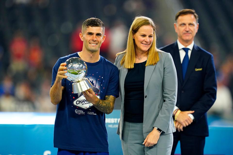 USA forward Christian Pulisic (10) poses for a photo op with U.S. Soccer president Cindy Parlow Cone after winning the “Best Player” award at Allegiant Stadium after defeating Canada.