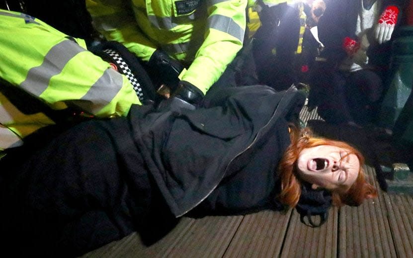 Police detain Patsy Stevenson at the memorial site for Sarah Everard in Clapham Common - Reuters