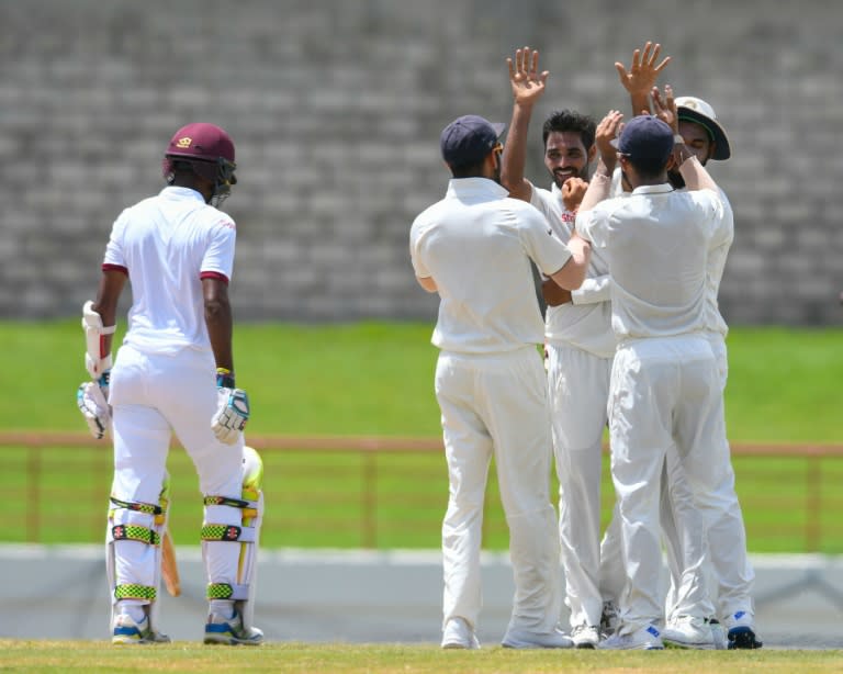 Bhuvneshwar Kumar (3L) of India celebrates the dismissal of Kraigg Brathwaite (L) of West Indies on August 13, 2016