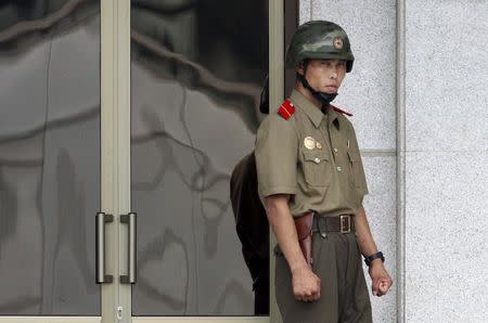 A North Korean soldier looks south from the North side at the truce village of Panmunjom, South Korea, July 22, 2015. REUTERS/Kim Hong-Ji