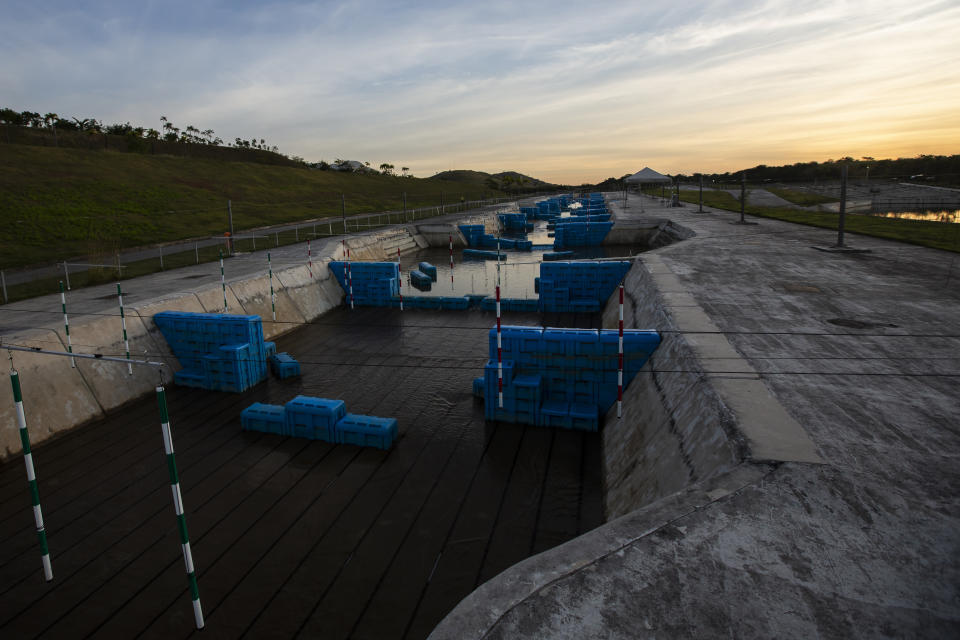 The sun sets over the Olympic canoe slalom circuit at Radical Park in Rio de Janeiro, Brazil, Thursday, June 24, 2021. With the Olympics about to kick off in Tokyo, the prior host is struggling to make good on legacy promises. (AP Photo/Bruna Prado)