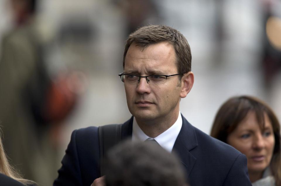 Andy Coulson, the ex-communications chief for Prime Minister David Cameron and former editor of the News of the World queues up as he arrives for his phone hacking case at the Old Bailey court in the City of London, Wednesday, Sept. 26, 2012. Eight people are appearing in court to face charges connected to the phone hacking scandal that rocked Rupert Murdoch's News Corp. empire. Rebekah Brooks, the former chief of News Corp.'s British newspapers, and Andy Coulson were among those appearing in court Wednesday. (AP Photo/Matt Dunham)