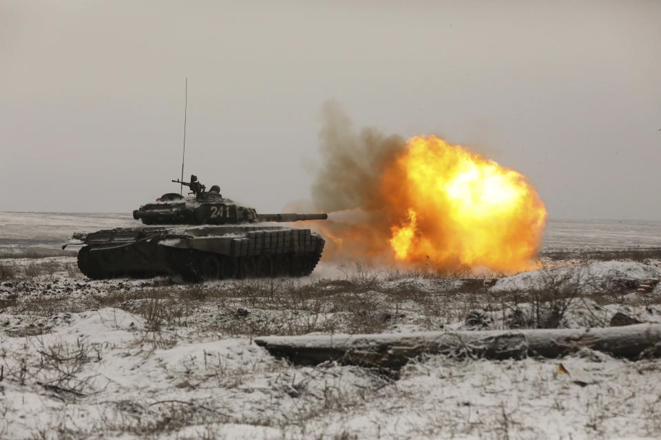 A Russian tank T-72B3 fires as troops take part in drills at the Kadamovskiy firing range in the Rostov region in southern Russia, Wednesday, Jan. 12, 2022. Russia has rejected Western complaints about its troop buildup near Ukraine, saying it deploys them wherever it deems necessary on its own territory. (AP Photo)