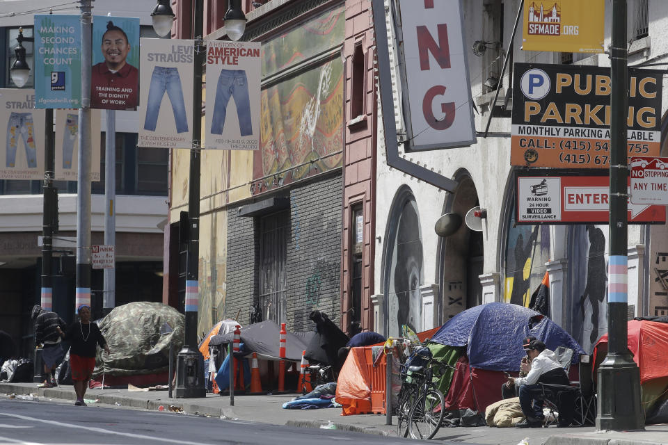 FILE - Tents line a sidewalk on Golden Gate Avenue in San Francisco, on April 18, 2020. Lawyers for San Francisco argued in appellate court Wednesday, Aug. 23, 2023, that workers can no longer maintain safe, clean streets while getting homeless people the help they need after a federal judge banned the city from clearing homeless encampments. Similar tensions are playing out in other U.S. western cities grappling with growing encampments. (AP Photo/Jeff Chiu, File)