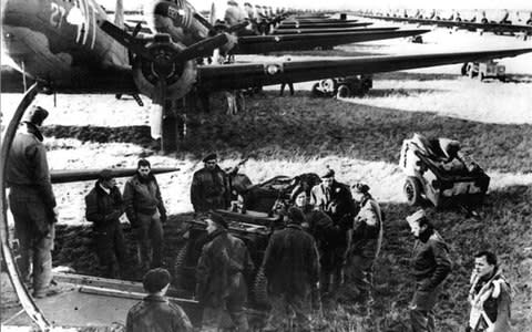 Allied aircrews work around C-47 transport planes at an unidentified English base in this file photo taken shortly before the D-Day landings in Normandy, France - Credit: AFP