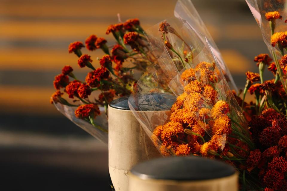 Marigold bouquets sit in water for sale on Cesar Chavez Avenue.