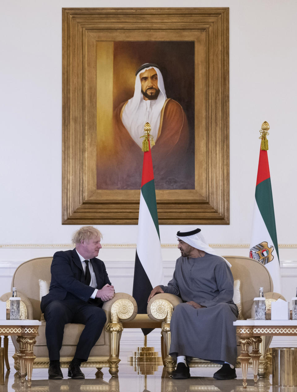 This photo made available by the Ministry of Presidential Affairs shows, the Prime Minister of the United Kingdom Boris Johnson, left, offering his condolences to Sheikh Mohamed bin Zayed Al Nahyan, President of the UAE and Ruler of Abu Dhabi, on the passing of Sheikh Khalifa bin Zayed Al Nahyan, late President of the UAE, in Abu Dhabi, UAE, Sunday, May 15, 2022. (Rashed Al Mansoori/Ministry of Presidential Affairs via AP)