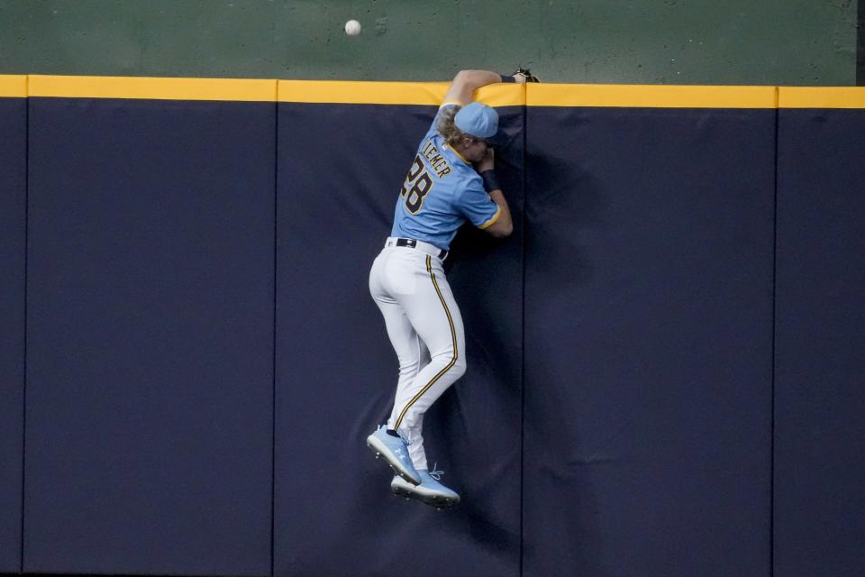 Milwaukee Brewers' Joey Wiemer can't catch a two-run home run hit by San Francisco Giants' Mitch Haniger during the second inning of a baseball game Friday, May 26, 2023, in Milwaukee. (AP Photo/Morry Gash)