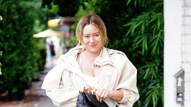 Hilary Duff wears a white top and green leggings while out running errands  in Los Angeles