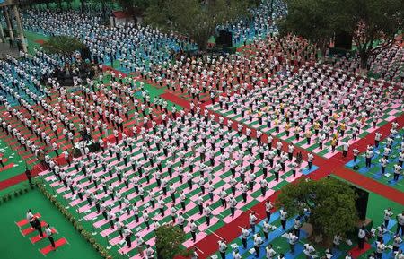 People perform yoga on International Yoga Day in Chandigarh, June 21, 2017. REUTERS/Ajay Verma