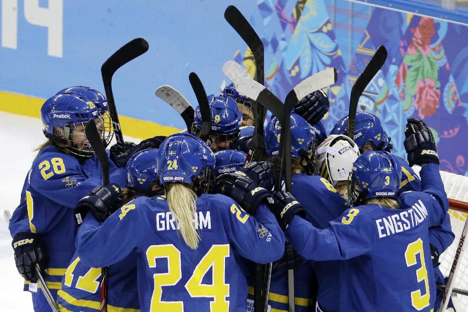 Team Sweden celebrates their 4-0 victory over Germany during the 2014 Winter Olympics women's ice hockey game at Shayba Arena, Tuesday, Feb. 11, 2014, in Sochi, Russia. (AP Photo/Mark Humphrey