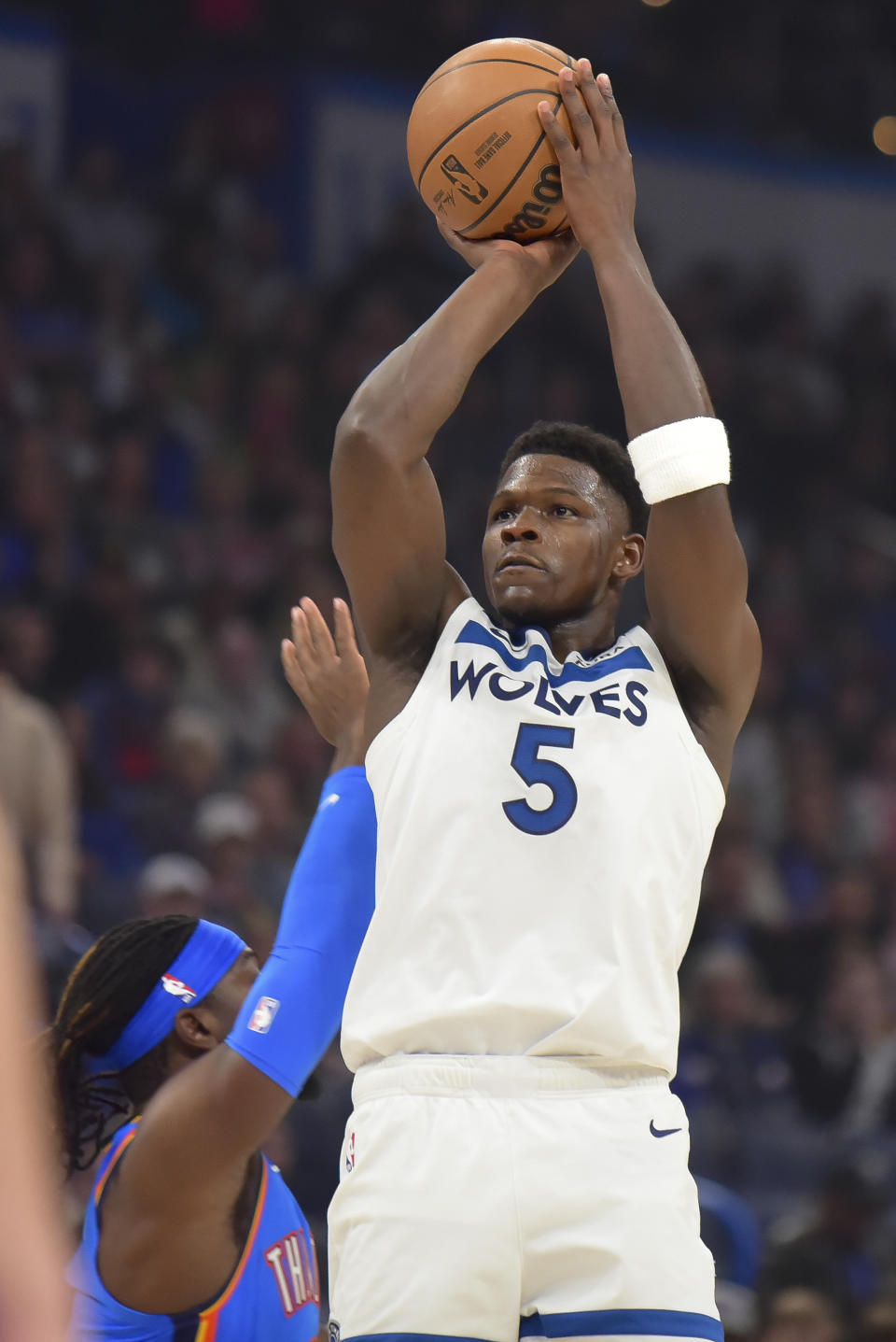 Minnesota Timberwolves guard Anthony Edwards, right, shoots next to Oklahoma City Thunder guard Luguentz Dort during the first half of an NBA basketball game Tuesday, Dec. 26, 2023, in Oklahoma City. (AP Photo/Kyle Phillips)