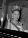 <p><b>Arriving at Buckingham Palace to attend a State banquet in a glittering tiara and pink gown. <em>[Photo: PA]</em> </b></p>