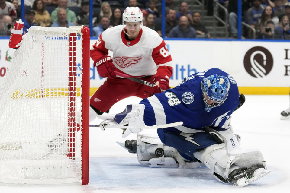 Tampa Bay Lightning goaltender Andrei Vasilevskiy (88) makes a save on a shot by Detroit Red Wings left wing Dominik Kubalik (81) during the first period of an NHL hockey game Tuesday, Dec. 6, 2022, in Tampa, Fla. (AP Photo/Chris O'Meara)