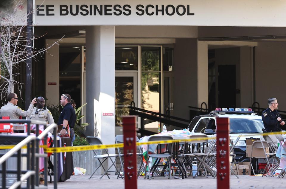 Police officers keep watch near the scene outside Frank and Estella Beam Hall, where the UNLV Lee Business School is located, the morning after a shooting left three dead at the University of Nevada, Las Vegas campus on 7 December 2023 in Las Vegas, Nevada (Getty Images)