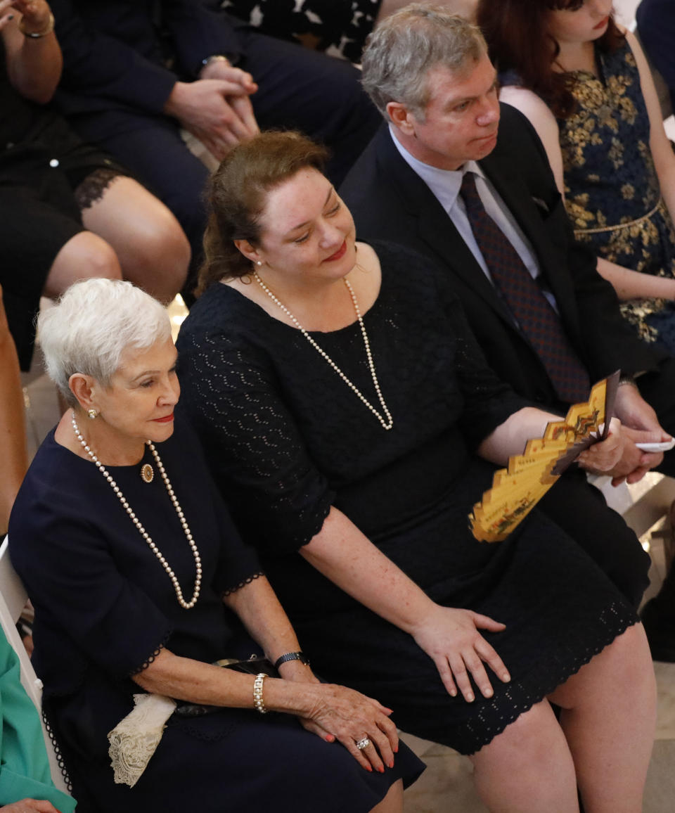 Kay Webber Cochran, left, widow of the late former U.S. Sen. Thad Cochran, and his daughter Kate Cochran, center, and son Clayton Cochran, right, listen to remarks during the first of two funeral services for the late Republican senator, in the Mississippi State Capitol rotunda in Jackson, Miss., Monday, June 3, 2019. Cochran was 81 when he died Thursday in a veterans' nursing home in Oxford, Mississippi. He was the 10th longest serving senator. (AP Photo/Rogelio V. Solis)