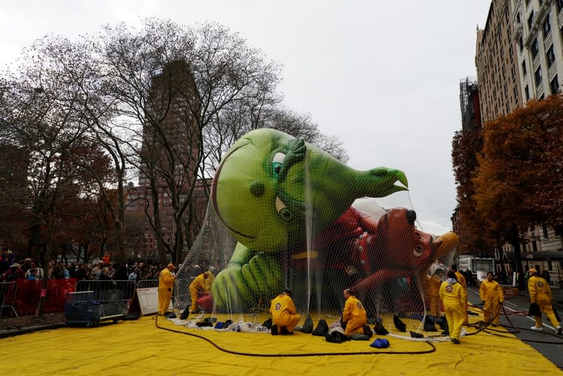 The Macy's Thanksgiving Day Parade inflation team makes preparations for the Grinch balloon in New York