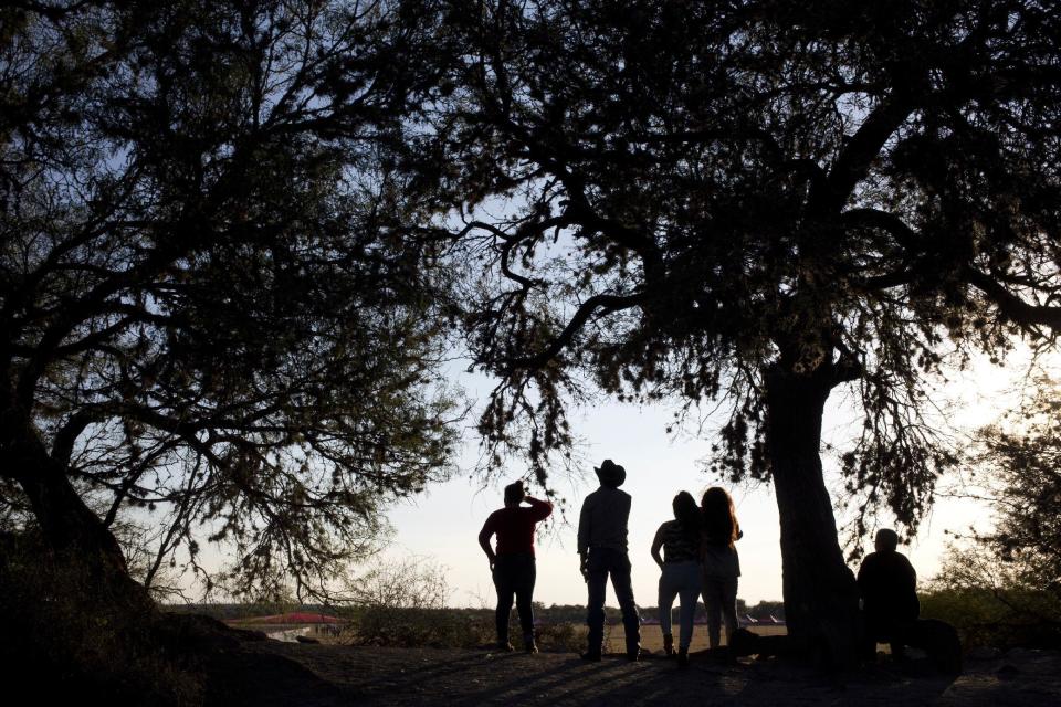 Visitors look at the esplanade where the down-home 15th birthday party for Rubi Ibarra will take place in the village of Laguna Seca, San Luis Potosi State, Mexico, Sunday, Dec. 25, 2016. Millions of people responded to the invitation for Rubi's Dec. 26th coming of age party in rural northern Mexico, after her parent's video asking "everybody" to attend went viral.(AP Photo/Enric Marti)