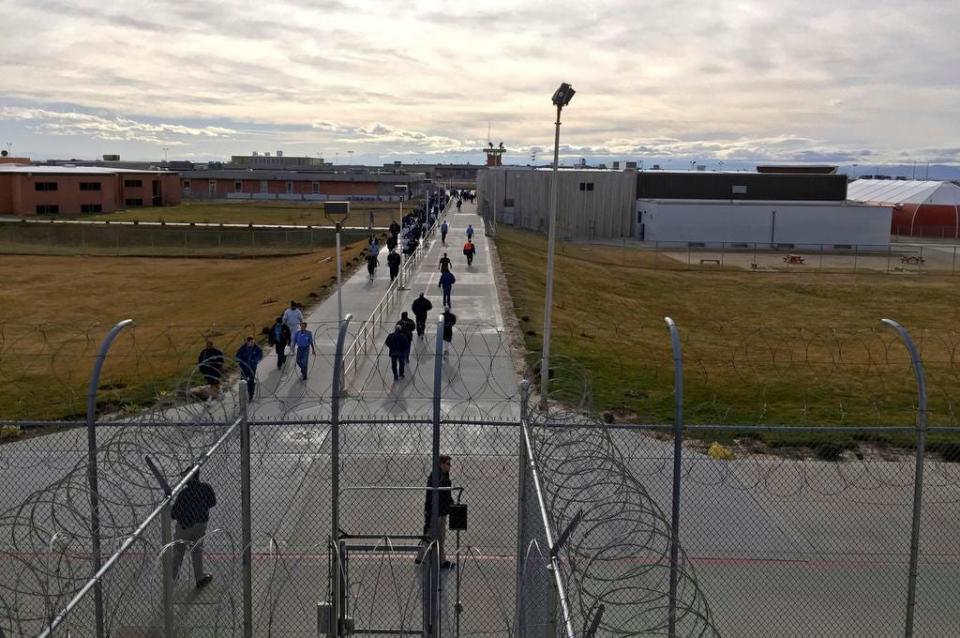 FILE - In this Jan. 30, 2018 file photo, inmates walk across the grounds of the Idaho State Correctional Institution in Kuna, Idaho. Idaho transgender inmate Adree Edmo has spent most of her prison term at this men's prison facility. A federal judge ruled Thursday, Dec. 13, 2018 that the state must provide Edmo with gender confirmation surgery to make her physical characteristics match her gender identity as a woman.