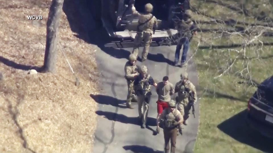 Jack Teixeira is taken into custody by armed tactical agents on April 13, 2023, in Dighton, Mass.  (WCVB-TV via AP)