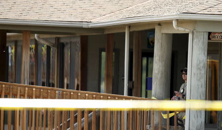 A law enforcement officer is seen outside of the Bridgewater Plaza in Moneta, Virginia, August 26, 2015. REUTERS/Chris Keane