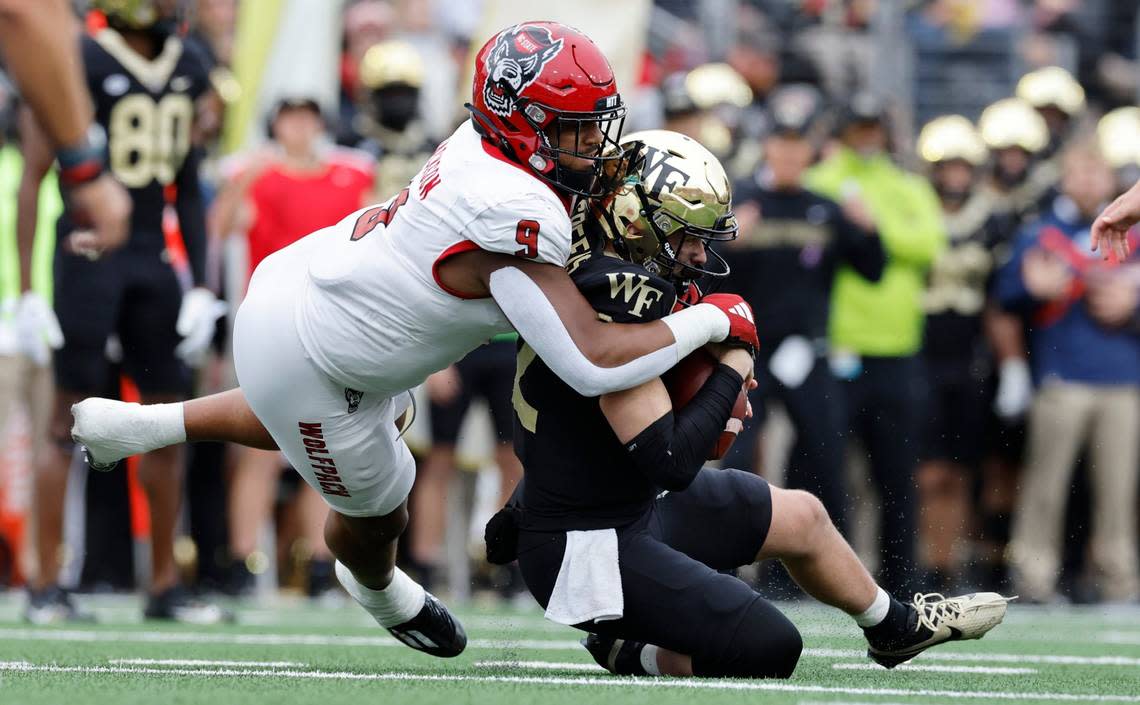 N.C. State defensive end Savion Jackson (9) sacks Wake Forest quarterback Mitch Griffis (12) during the first half of N.C. State’s game against Wake Forest at Allegacy Stadium in Winston-Salem, N.C., Saturday, Nov. 11, 2023. Ethan Hyman/ehyman@newsobserver.com