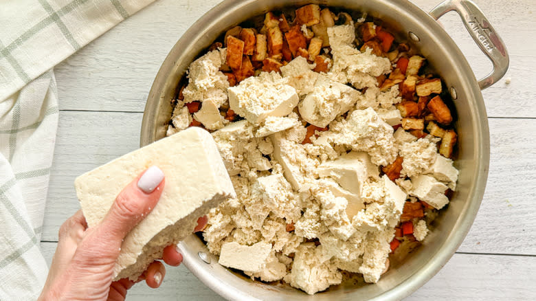 crumbling tofu in pan