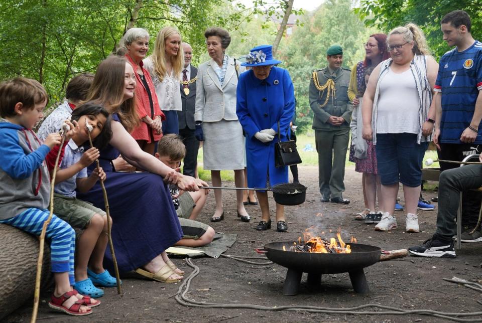 Queen Elizabeth II and Princess Anne, Princess Royal view marshmallows being toasted as they visit the Children's Wood Project,  a community project in Glasgow as part of her traditional trip to Scotland for Holyrood Week on June 30, 2021 in Glasgow, Scotland. (Getty Images)