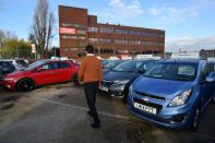 Ameen Sultani walks as he shows some of the older, cheaper vehicles that have been popular with customers eager to avoid public transport during the coronavirus disease (COVID-19) pandemic, in Hayes