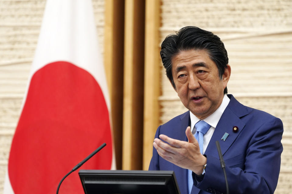 FILE - In this May 4, 2020, file photo, Japan's Prime Minister Shinzo Abe speaks during a press conference at his official residence in Tokyo. Prime Minister Abe on Monday became Japan's longest-serving leader in terms of consecutive days in office, but there was little fanfare, as he visited a hospital for another health checkup amid concerns about his health.(AP Photo/Eugene Hoshiko, Pool)